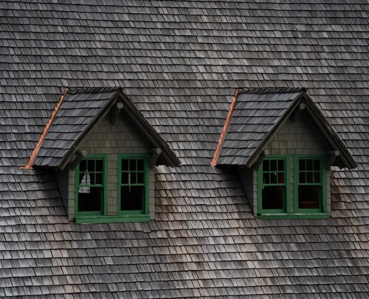 Dormers on a shingle roof in New Braunfels, TX, where step flashing and kickout flashing carry water past the walls