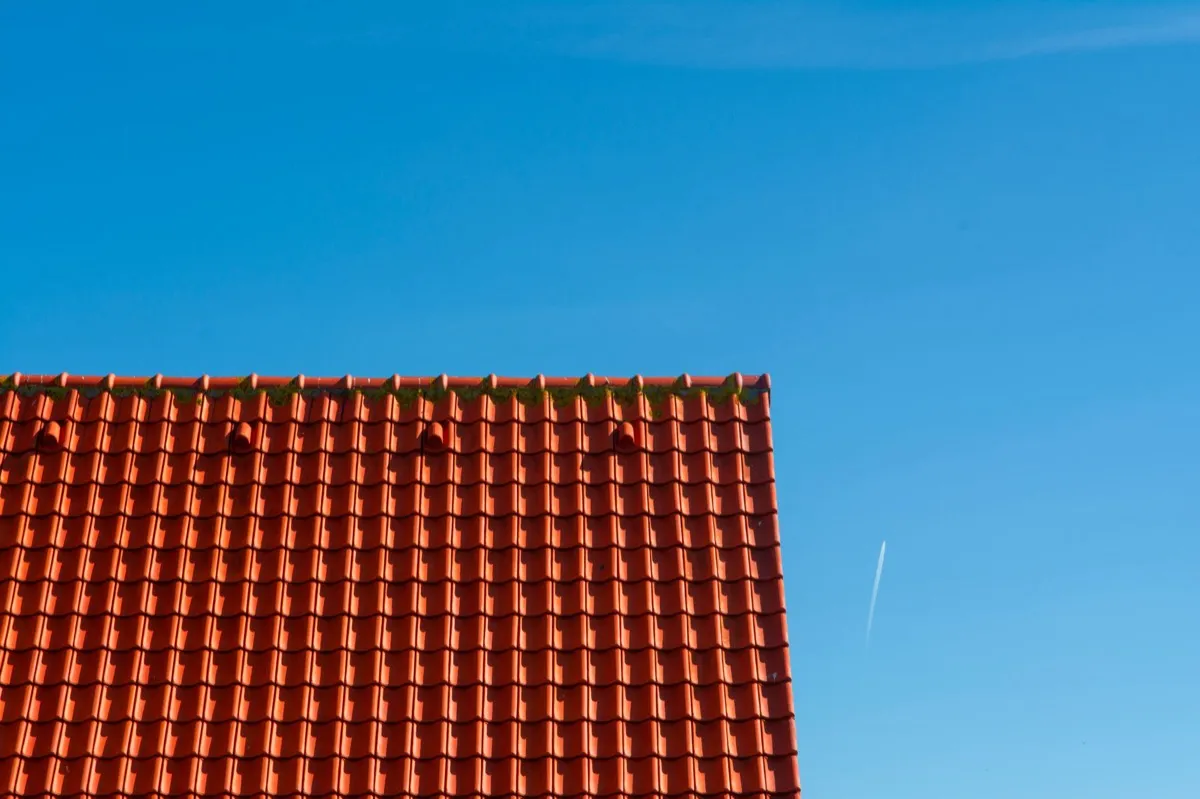 Tile roof gable in full sun, the kind of exposure that sets roof life in New Braunfels, TX